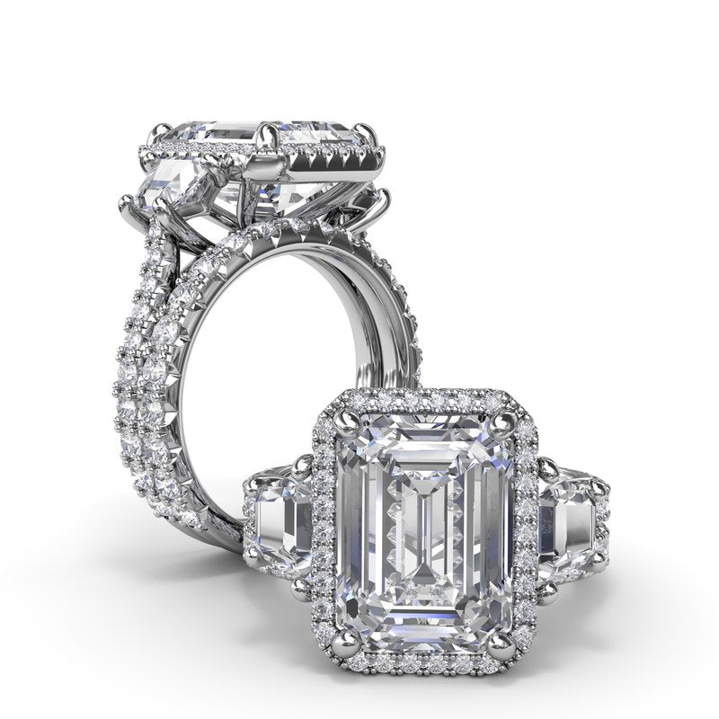 Halo three-stone diamond ring, white gold.