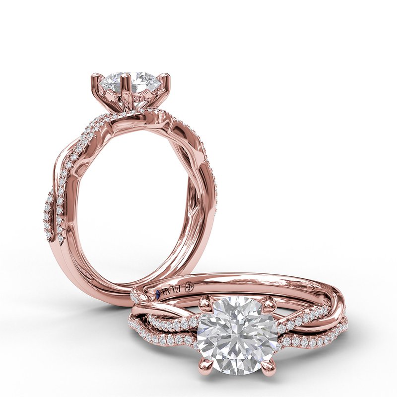 Rose gold engagement ring with round diamonds and sapphire.