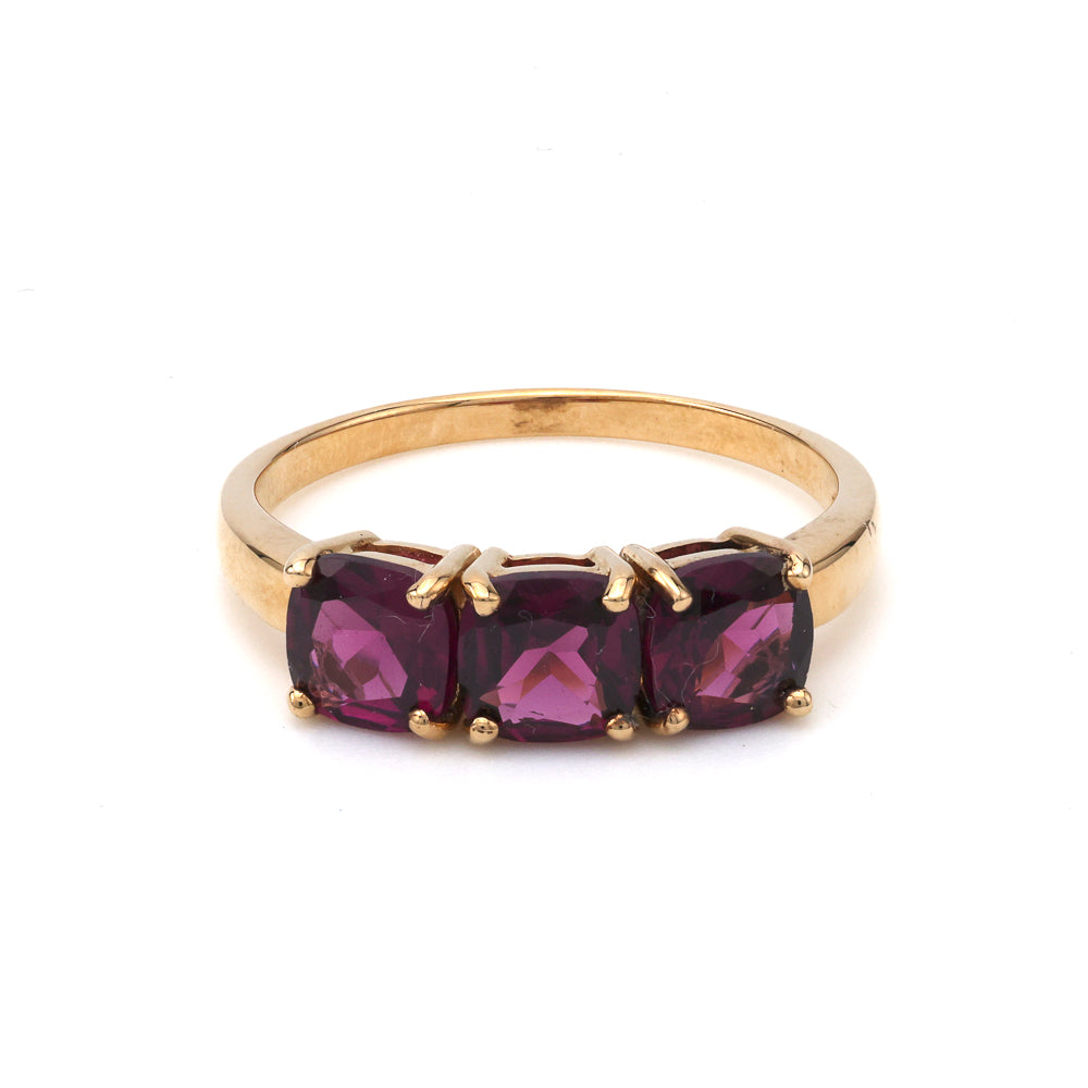 Three rhodolite garnets in yellow gold ring.