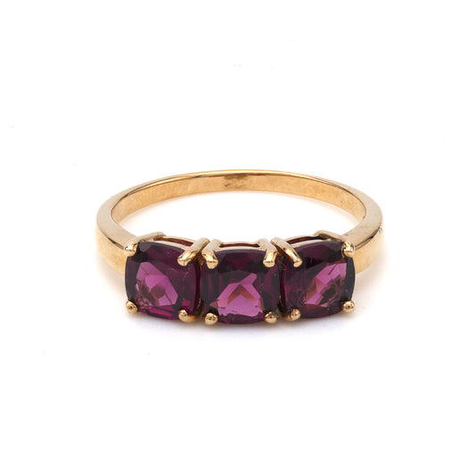 Three rhodolite garnets in yellow gold ring.