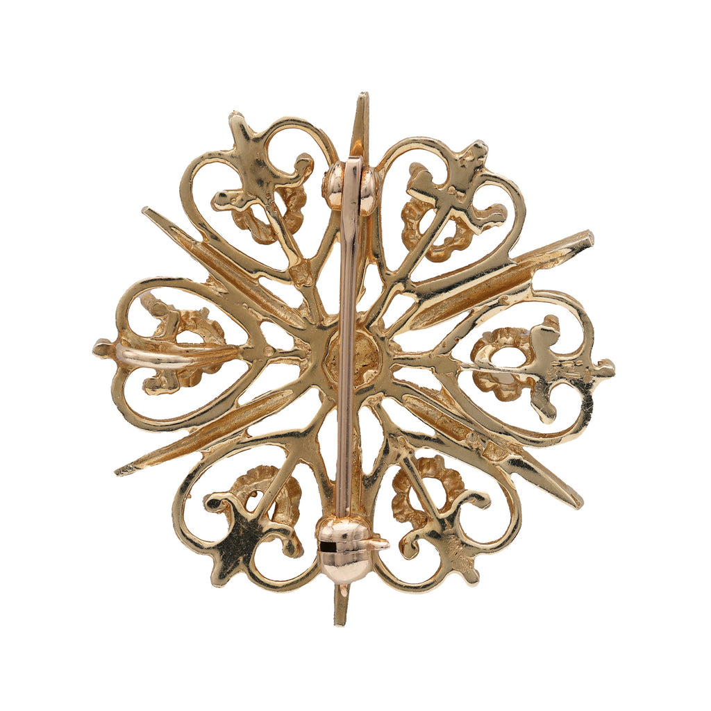 Starburst opal pin in yellow gold.