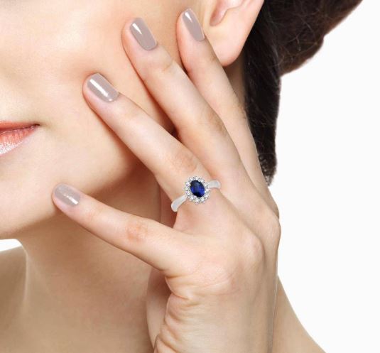 Oval blue sapphire ring with diamond accents.