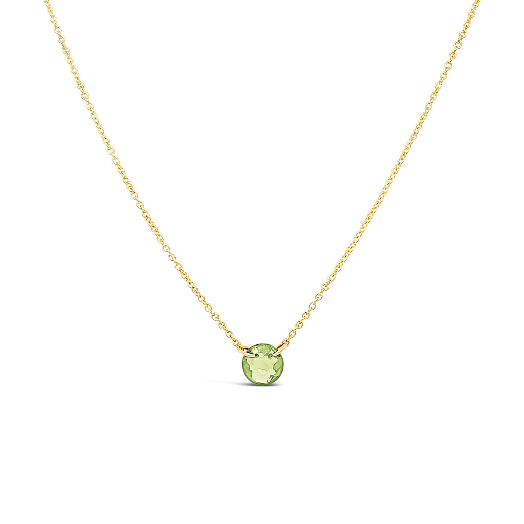 Gold chain with round green peridot pendant.