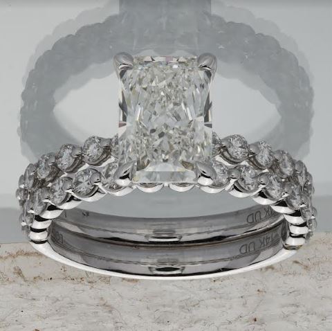 Radiant diamond wedding set with round accents.