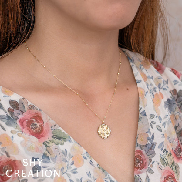 Gold pendant necklace with diamond accents.