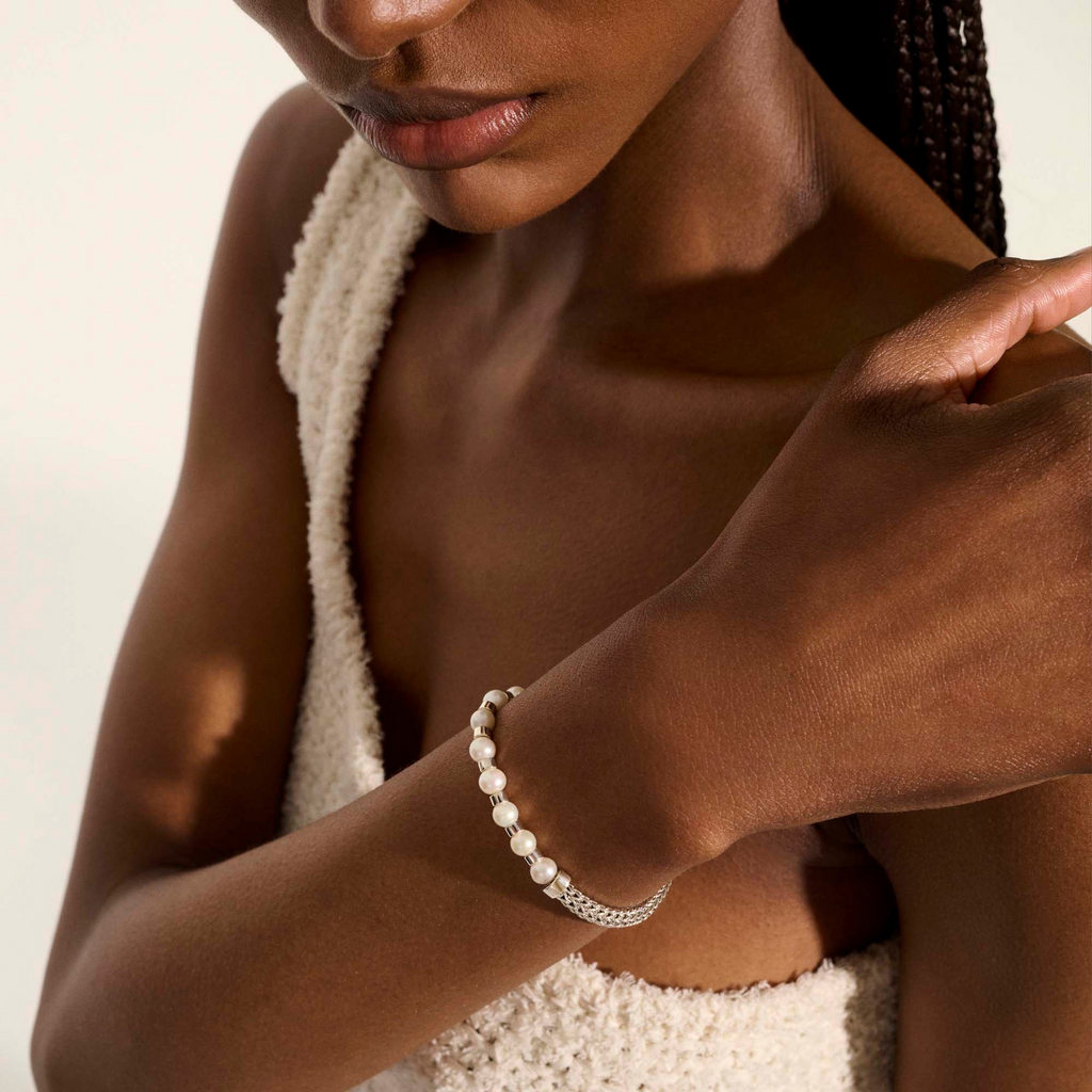 Sterling silver bracelet with cultured pearls and hidden clasp.