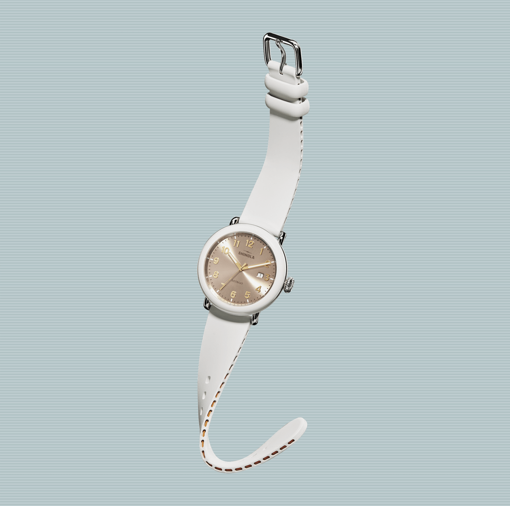 Rose dial, white rubber strap, stainless steel case.