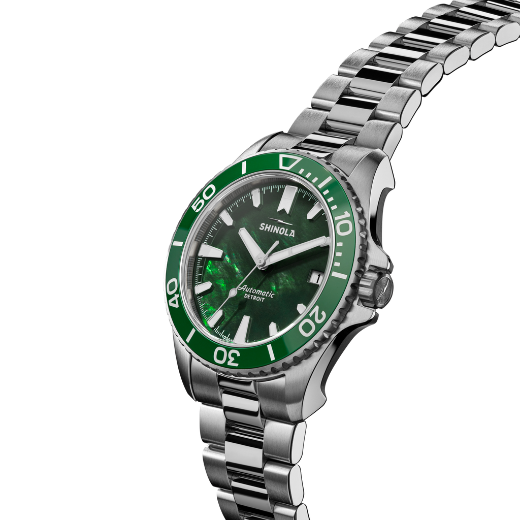 Green-dial stainless steel automatic watch.