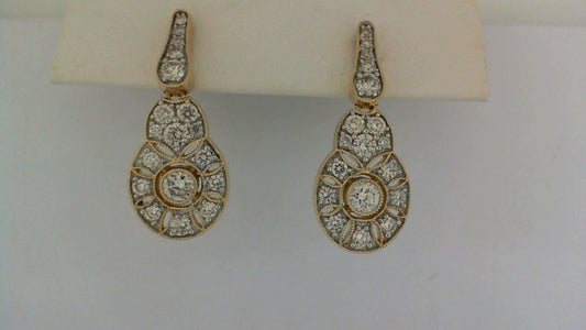 Gold drop earrings with round diamonds.