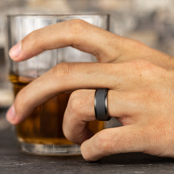 Tantalum grey carved band on hand.