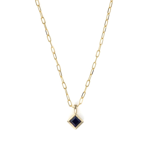 Yellow gold necklace with blue sapphire pendant.