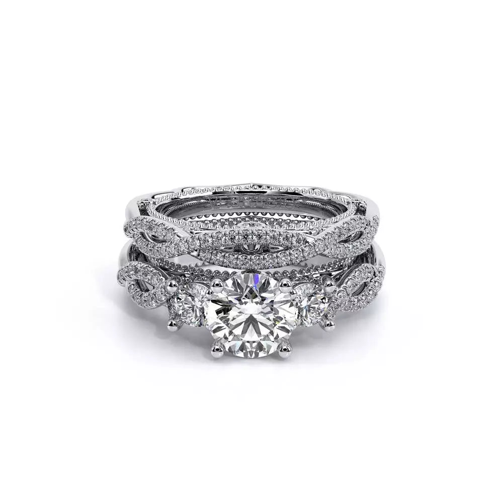 Three-stone diamond ring with intricate band design.