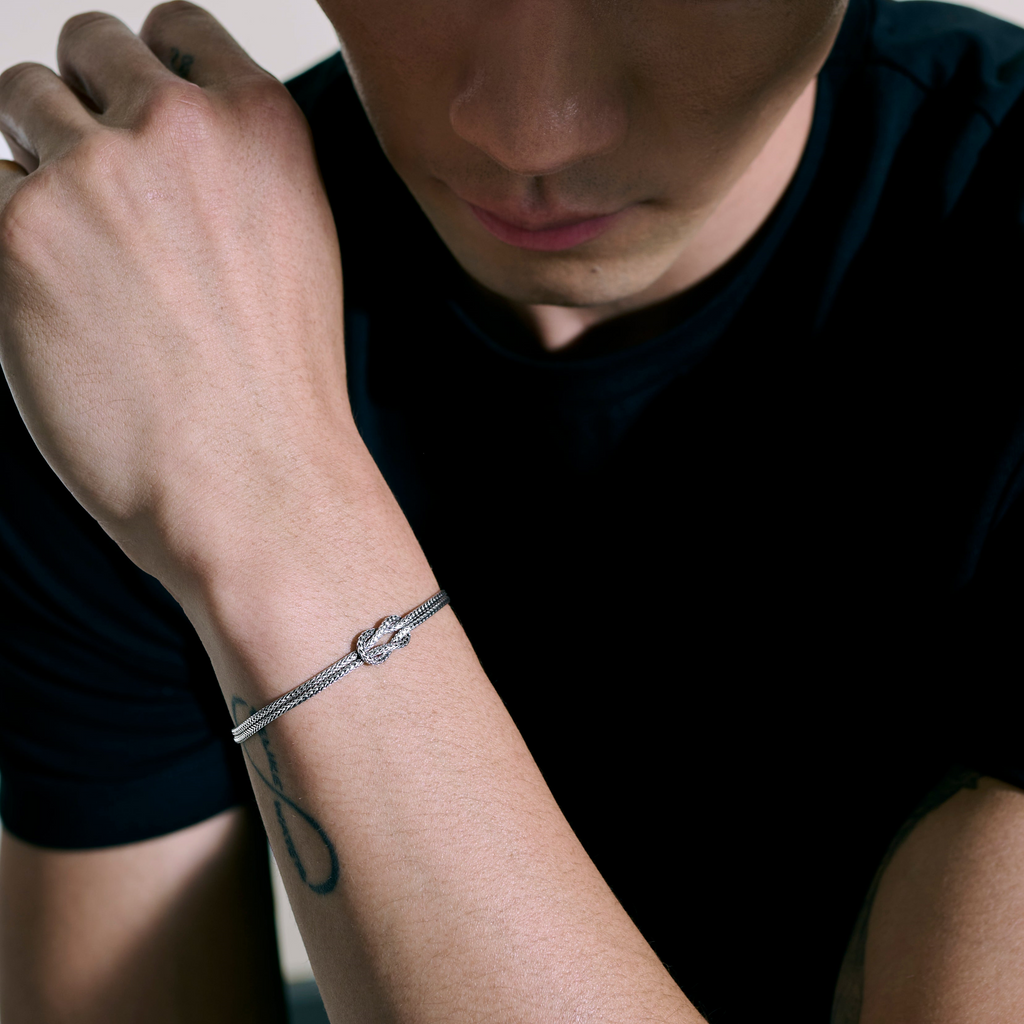 Sterling silver bracelet with knot design.