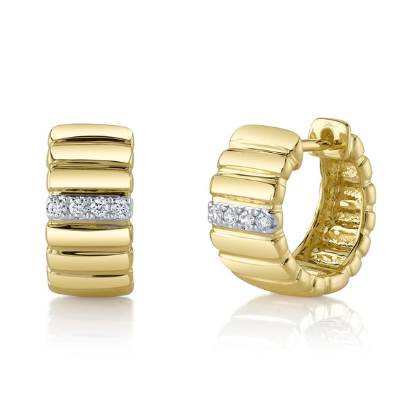 Gold huggie earrings with diamond accents.