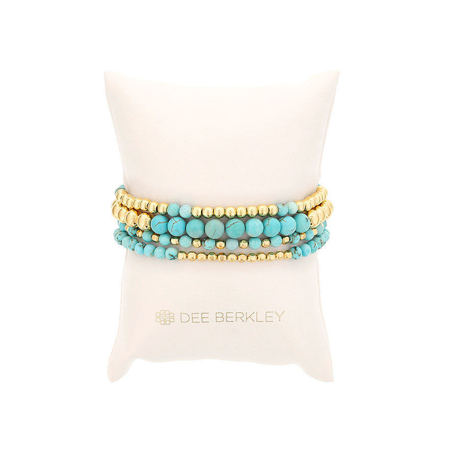 Round blue Howlite bracelet with gold beads.