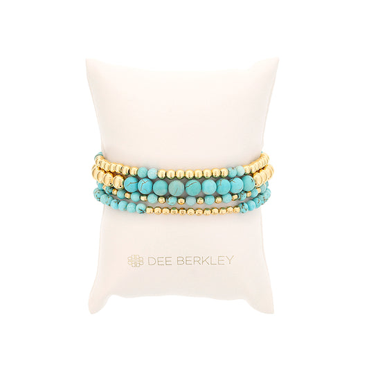 Round blue Howlite bracelet with gold beads.
