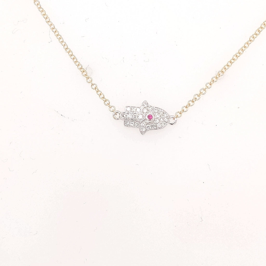 Hamsa necklace with diamonds and central ruby.