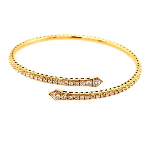 Flexible yellow gold bangle with round diamonds.