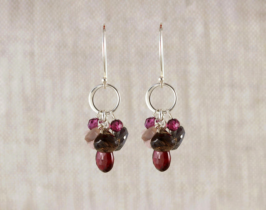 Sterling silver hoops with colorful gemstones.