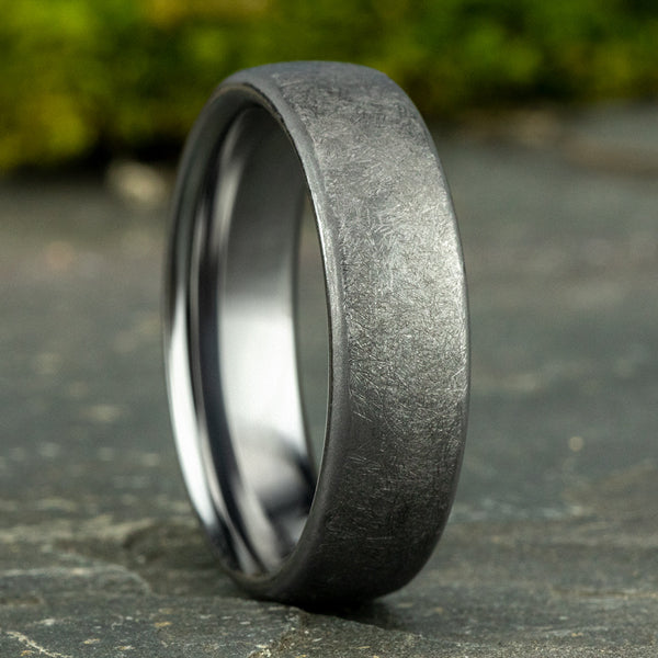 Satin-finish grey tantalum carved band.