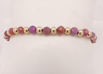 Round ruby gemstone bracelet with gold beads.
