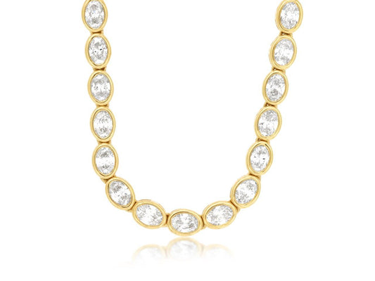 Oval diamond necklace in yellow gold setting.
