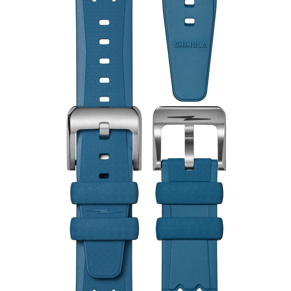 Blue textured rubber watch strap, stainless steel buckle.