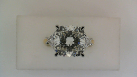 Three-stone diamond ring in white-yellow gold.