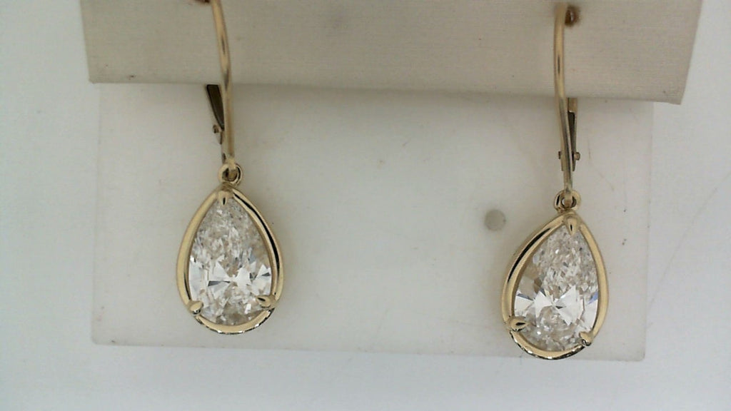 Pear-shaped lab-grown diamond earrings in gold setting.