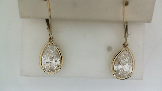 Pear-shaped lab-grown diamond earrings in gold setting.