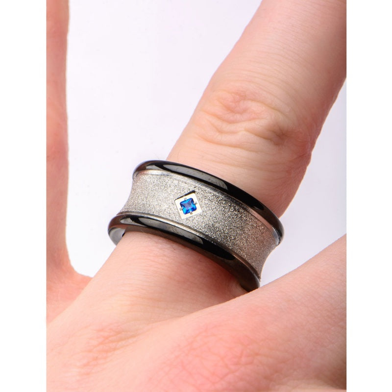 Stainless steel ring with blue sapphire.