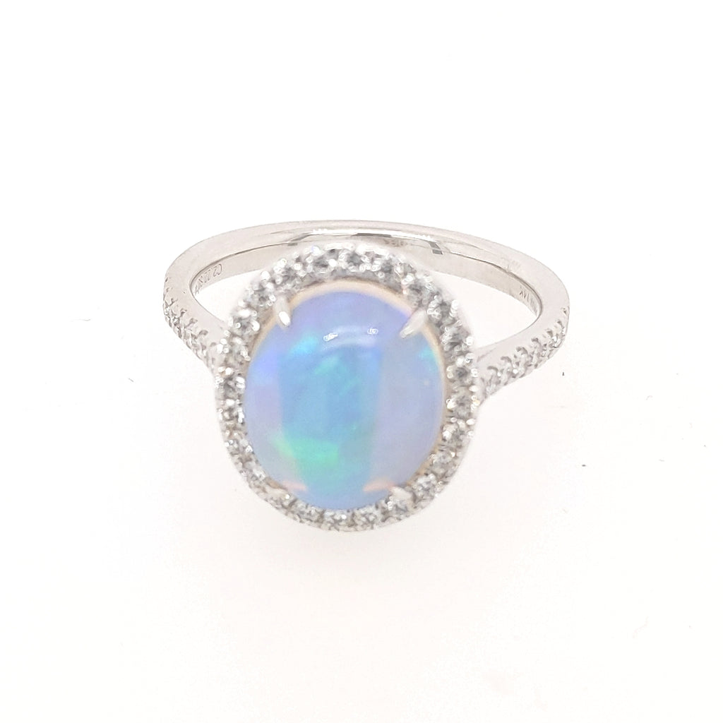 Opal ring with diamond halo setting.