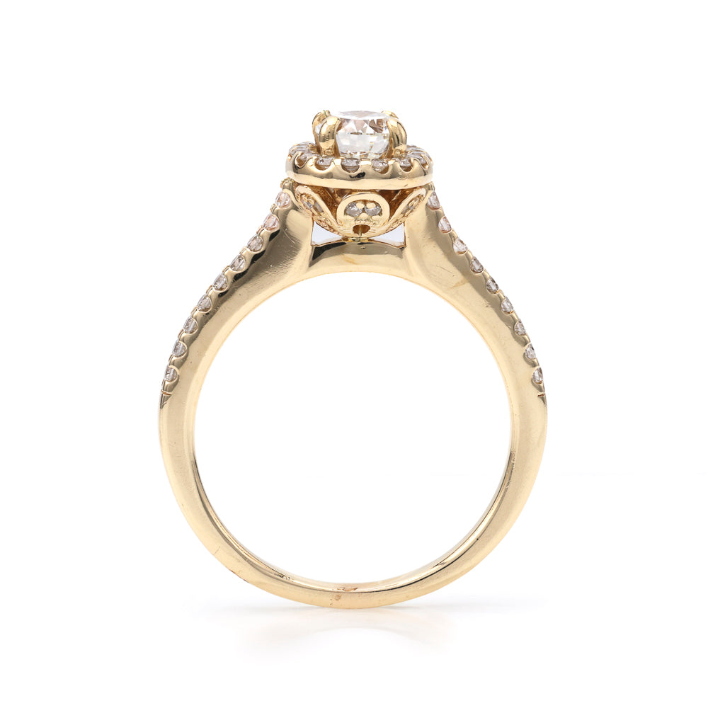 Halo oval diamond yellow gold ring.