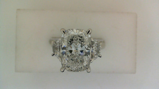 Three-stone cushion diamond engagement ring.