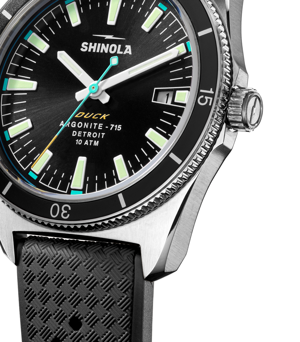 Black dial stainless steel watch, rubber strap.