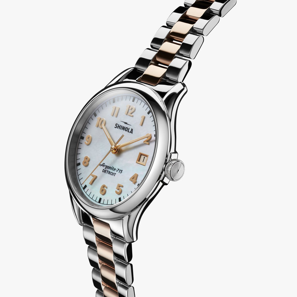Stainless steel watch with mother of pearl dial.
