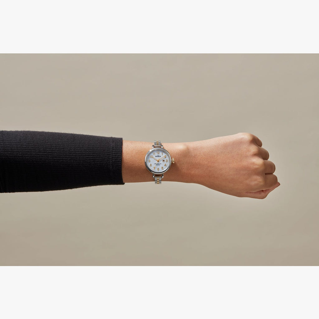 Stainless steel watch with mother-of-pearl dial.