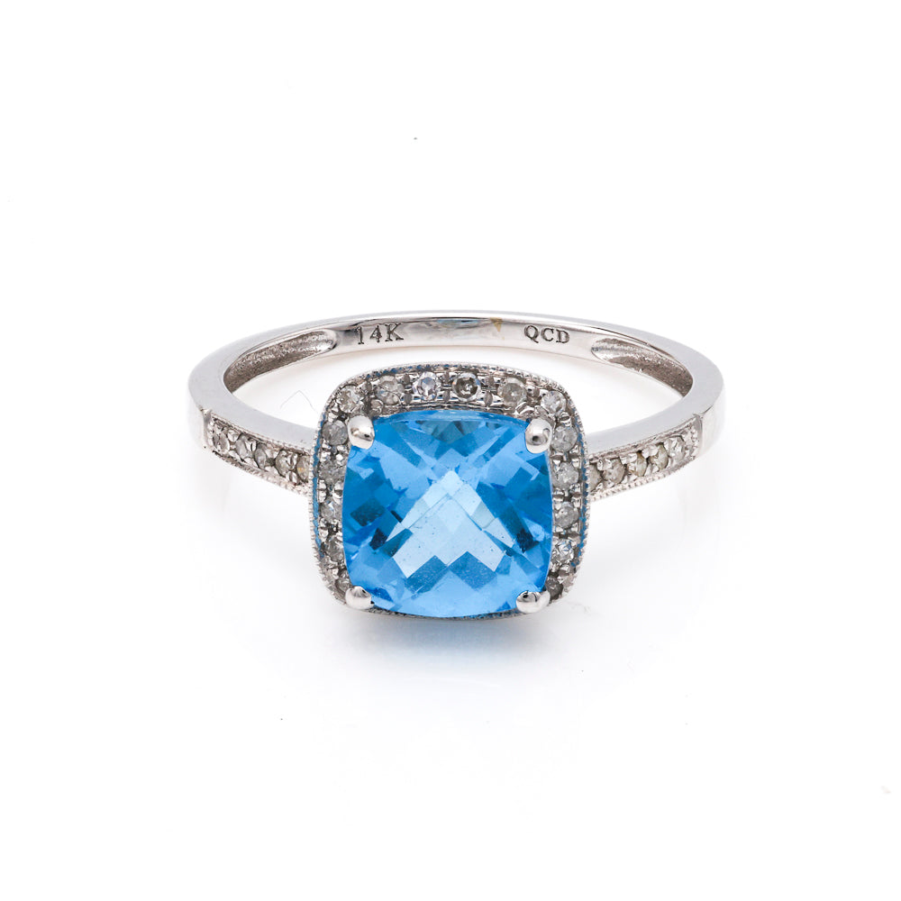 Cushion blue topaz ring with diamonds.