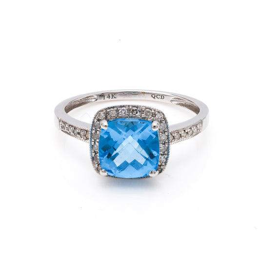 Cushion blue topaz ring with diamonds.