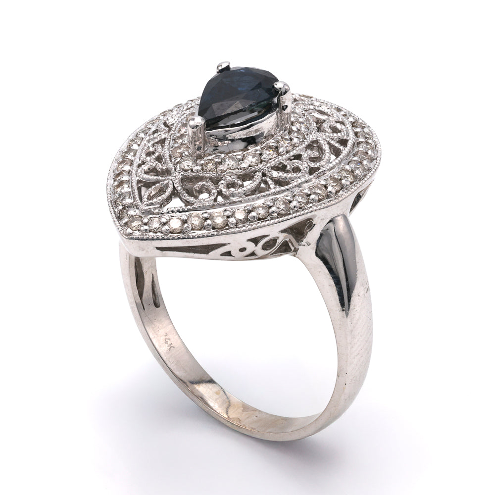 Pear sapphire ring with intricate diamond setting.