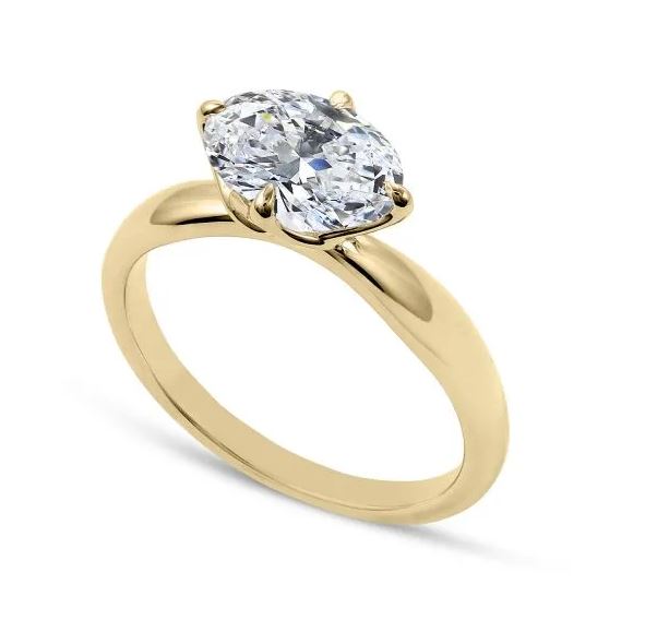 Oval diamond yellow gold engagement ring.