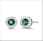 Emerald and diamond stud earrings in gold.