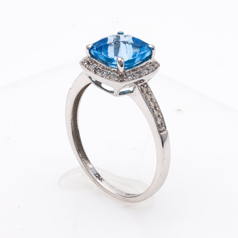 Cushion blue topaz ring with diamonds.