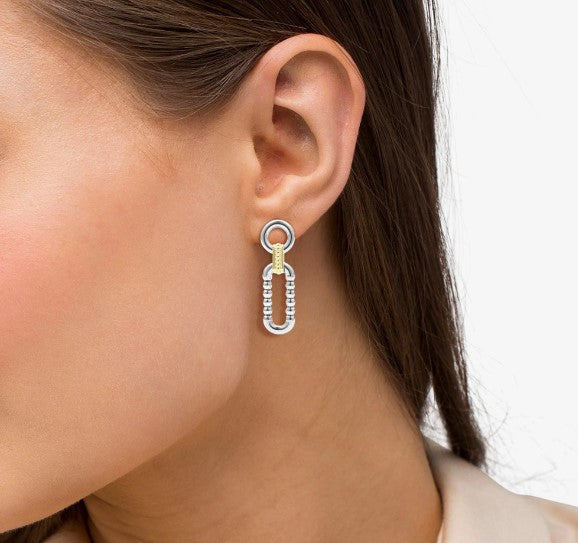 Sterling silver and gold dangle earrings.