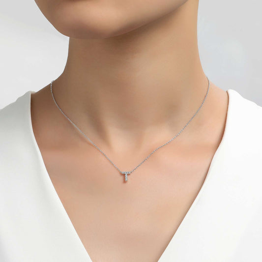 Simulated diamond initial necklace on neck.