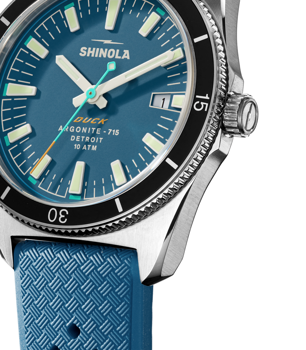 Blue dial watch with textured rubber strap.