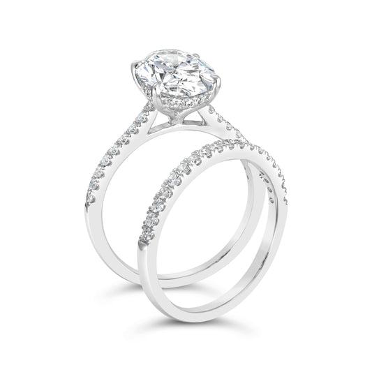 Oval diamond ring with side stones, white gold.