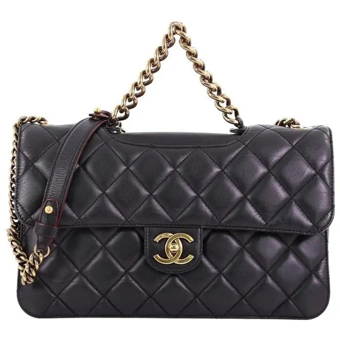 Black quilted leather handbag with gold chain.