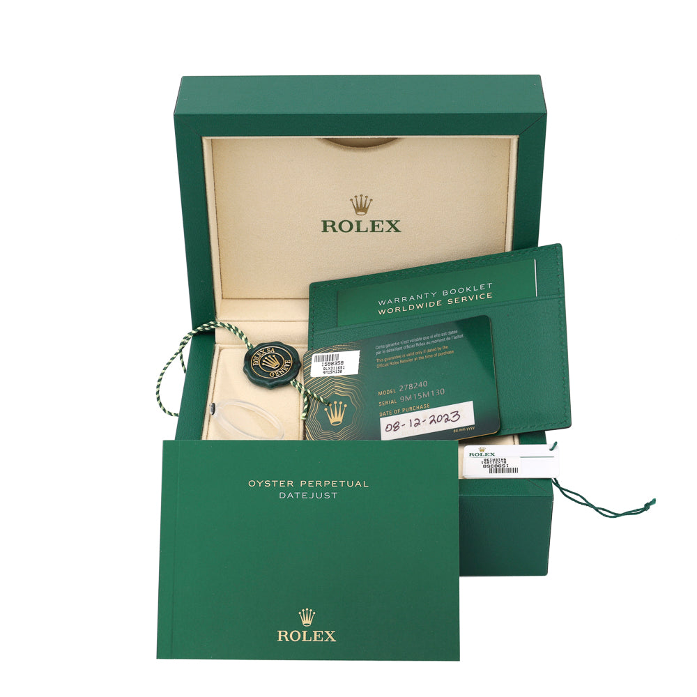 Green watch box with warranty booklet.