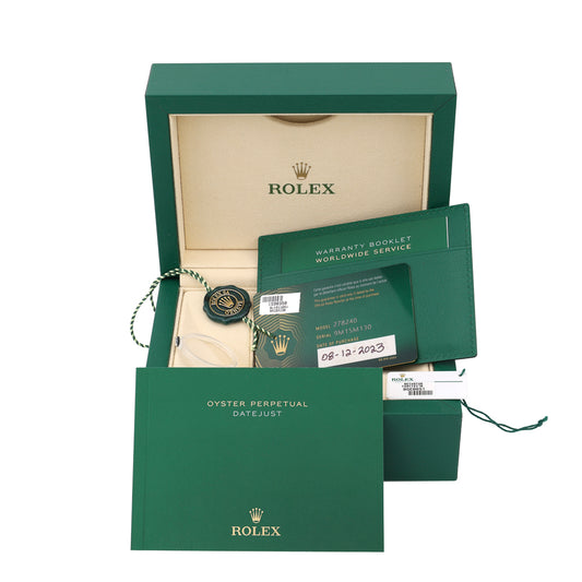 Green watch box with warranty booklet.